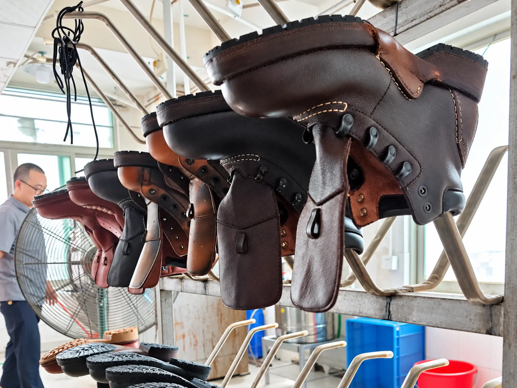 Leather boots suspended during production in the Qineng workshop
